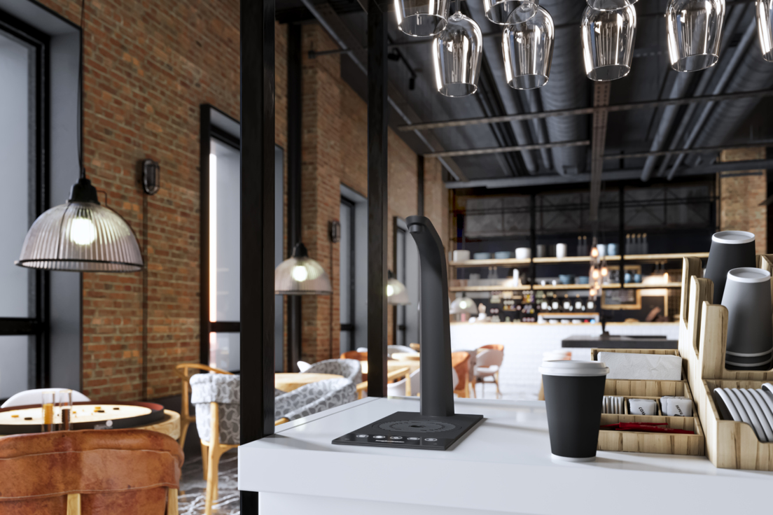 Modern office kitchen with a sleek bottleless water system, illustrating sustainable workplace hydration solutions provided by Cleartide.