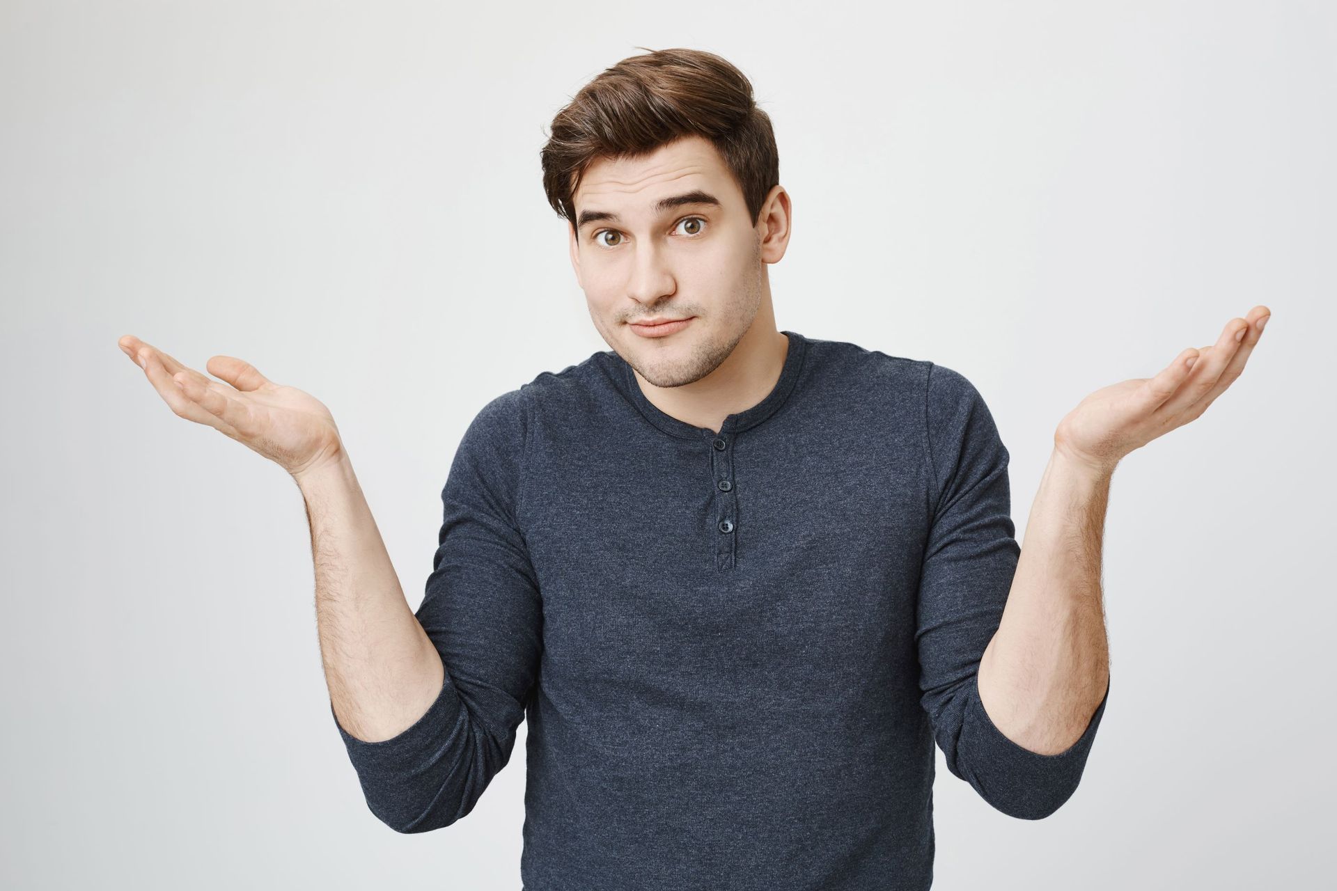 Man with hands up wondering if  bottleless water systems really more costly than traditional water coolers?