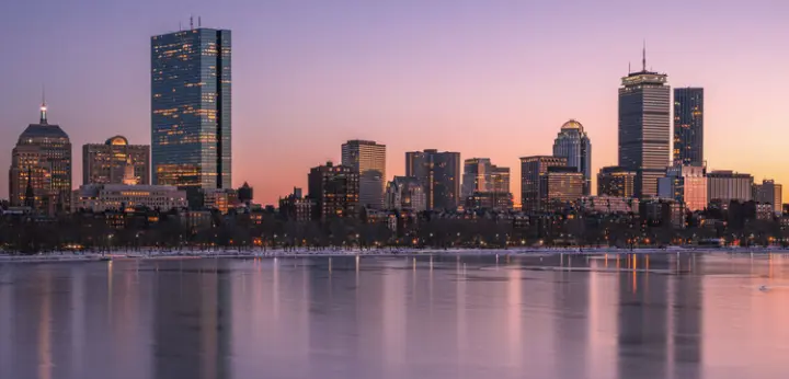 Boston skyline at dusk, highlighting sustainable business solutions with Cleartide Hydration bottleless water systems