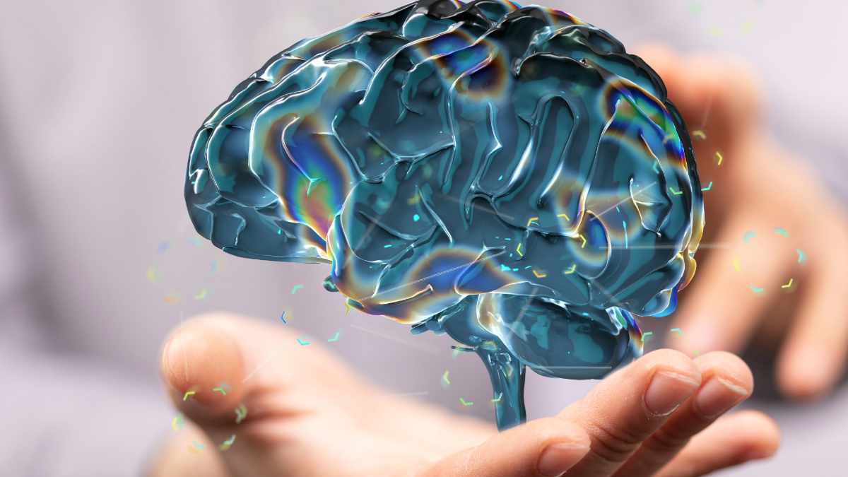 A 3D illustration of a brain being held, representing cognitive abilities and the impact of hydration. Cleartide bottleless water in Boston helps support cognitive performance in children.