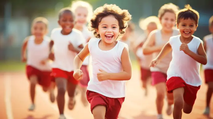 Group of children running on a school track, symbolizing healthy hydration alternatives in schools through sustainable bottle-less water systems