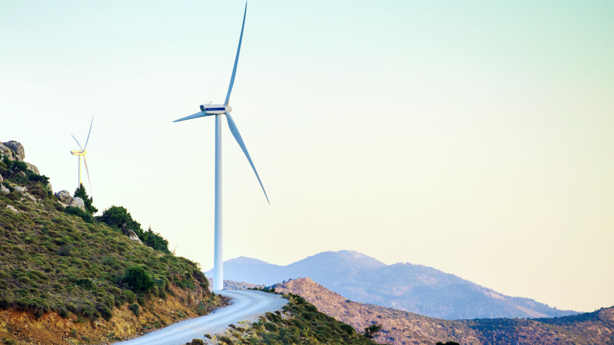 Wind turbines on a hillside representing Cleartide's commitment to sustainability and eco-friendly advancements in the beverage industry.